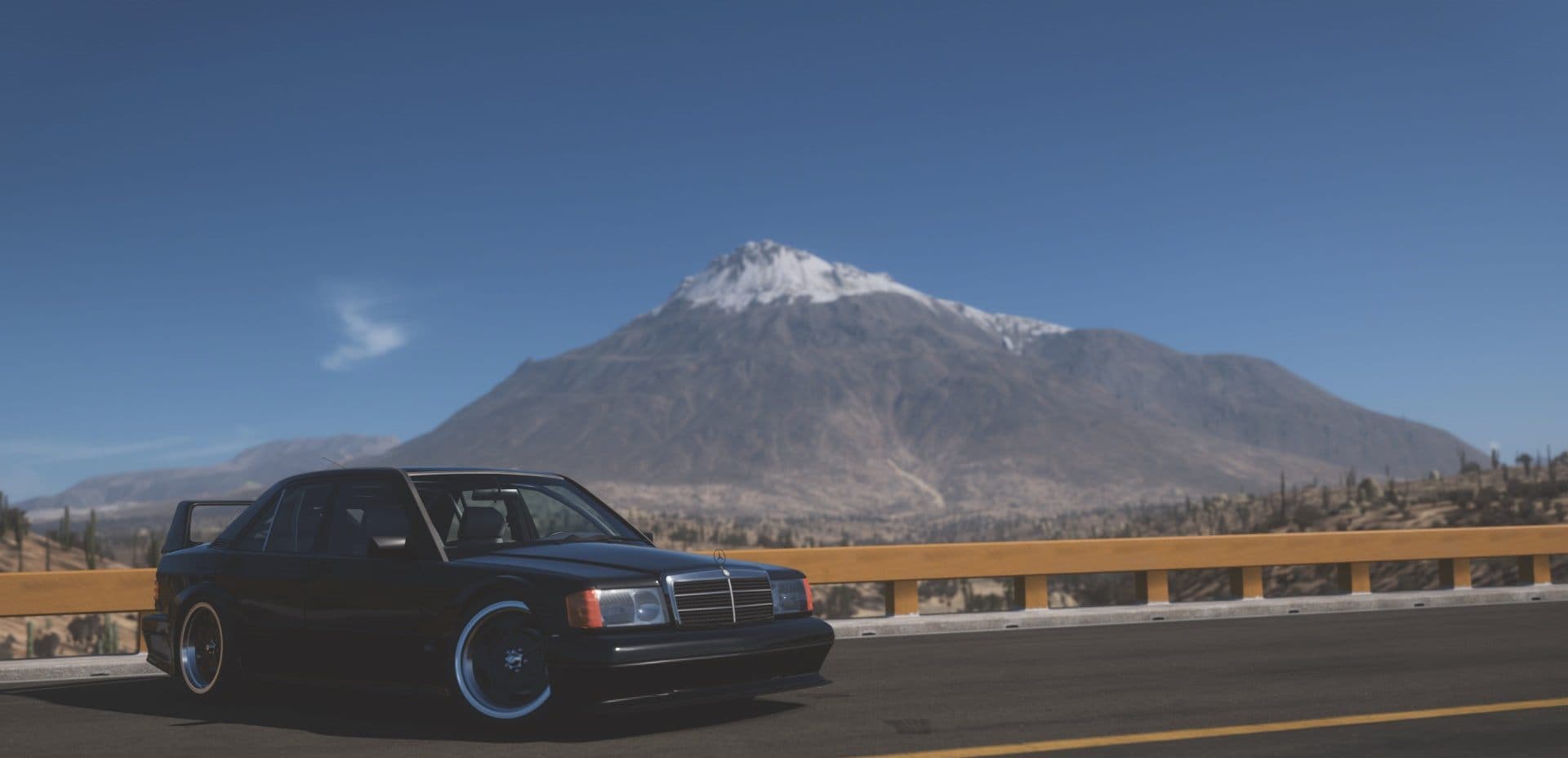 A tuned Mercedes-Benz 190E on a mountain road